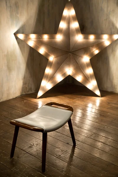 Studio decorated with l wooden star with light bulbs