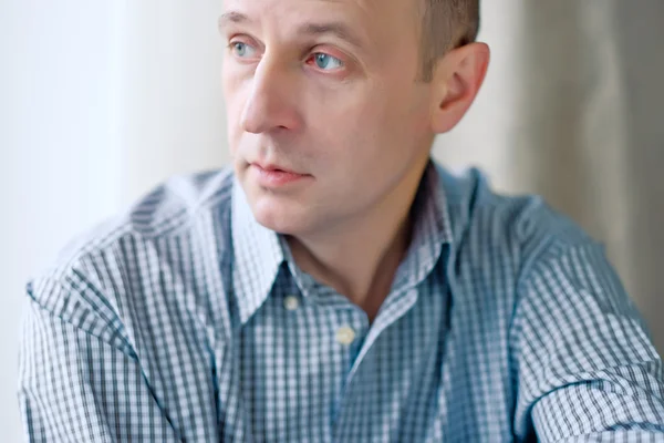 Portrait of smart bald man wearing a striped shirt