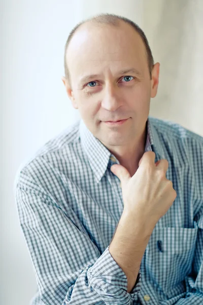 Portrait of smart bald man wearing a striped shirt