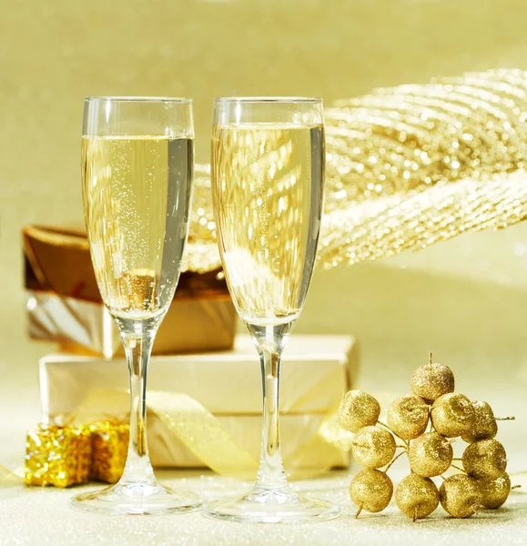 Two champagne glasses on wooden table