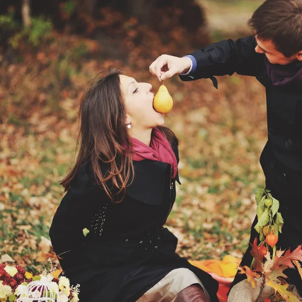 Young sweet couple having date in autumn park.