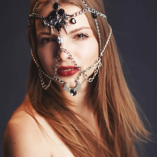 Young girl with chain mask