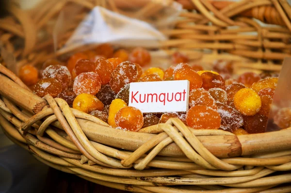 Dried sugared kumquat in wicker basket