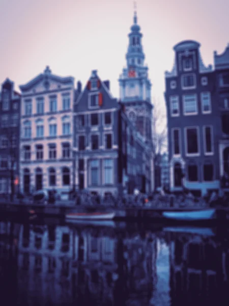 Amsterdam houses over the canal  and their reflection in the water. Blurred toned photo.