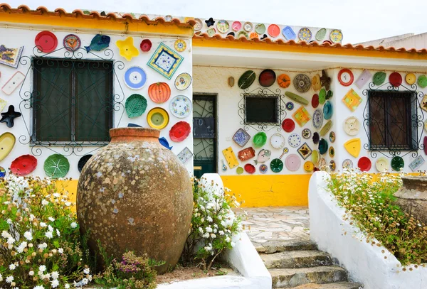 ALGARVE, PORTUGAL - MAY 3, 2015: Traditional colorful ceramic plates on the wall of the local pottery shop.  Algarve is famous for its hand-painted pottery and ceramics.