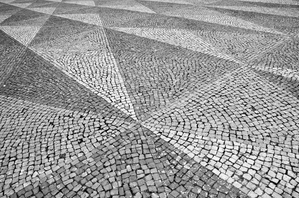 Mosaic tiles pavement background. Triangle paving. Black and white.