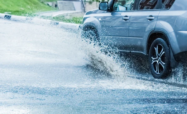 Car rain puddle splashing water