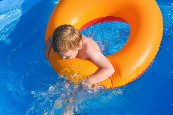 Little boy on an inflatable circle in the water