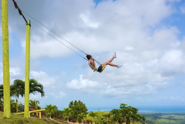 Woman swinging high