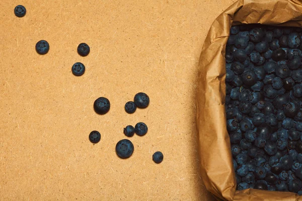 Raw food concept. Box with fresh blueberries packed in ecological material