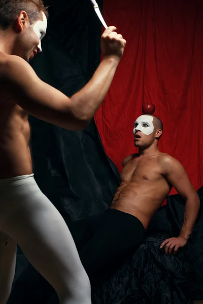 Bulls eye concept. Two muscular mime artists, clowns with white
