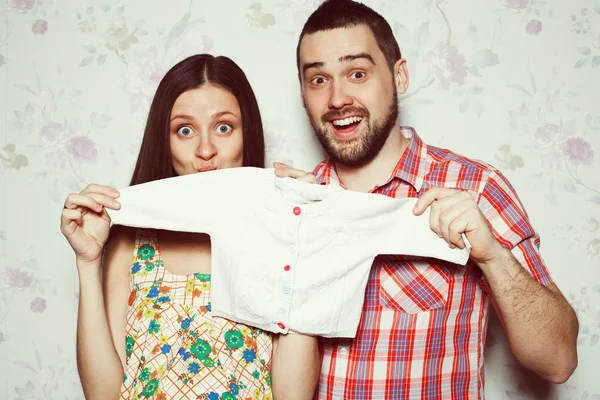Stylish pregnancy concept: portrait of funny couple of hipsters