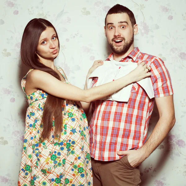 Stylish pregnancy concept: portrait of funny couple of hipsters