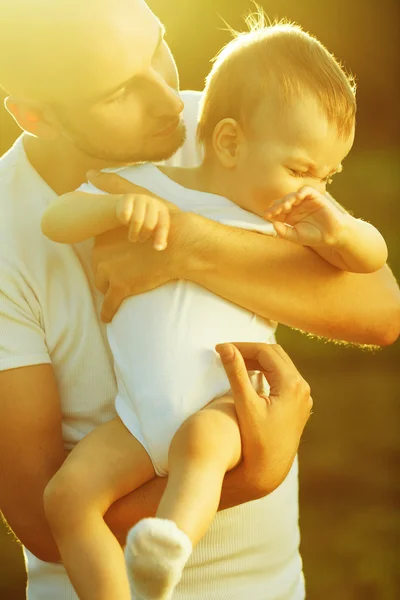 Paternity concept. Profile portrait of father and crying little son