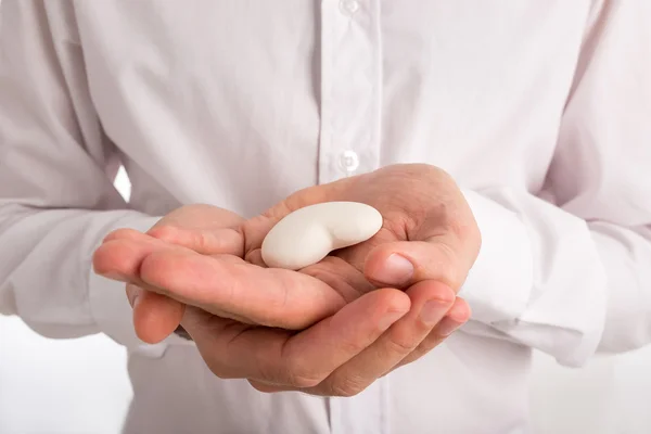 Close Up of Man Holding White Heart in Hands