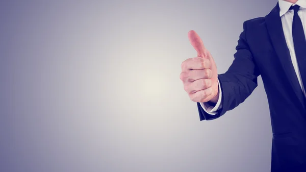 Businessman giving a thumbs up gesture in a business motivation