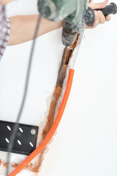 Repairman Installing Orange Corrugated Conduit