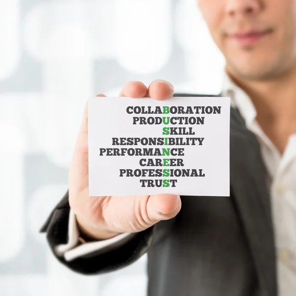 Man Holding Card with Business and Related Words