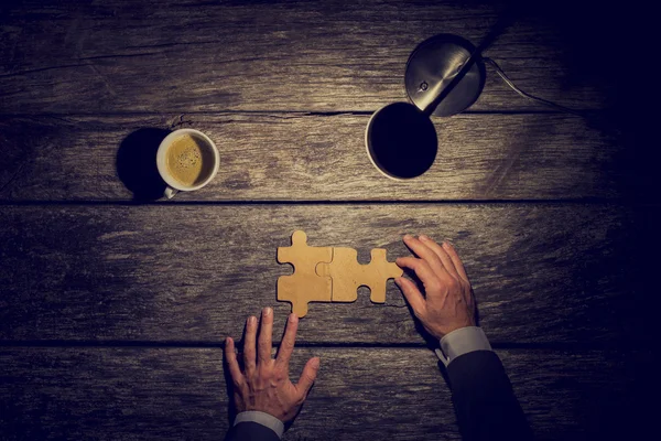 Overhead view of businessman working late at night at his rustic