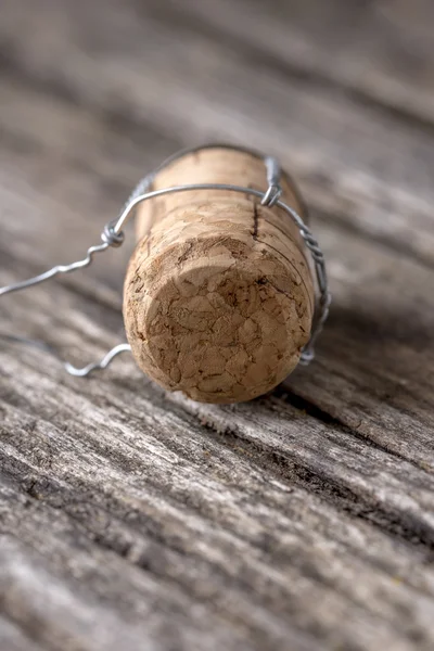 Champagne cork lying on wooden boards