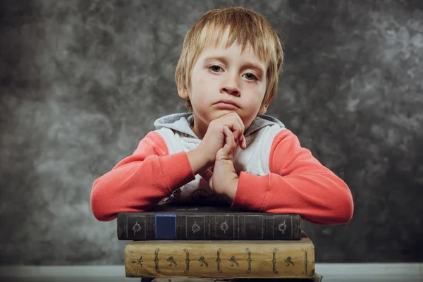 Sad Boy 5 Years Old Sitting with Books, Learning Concept
