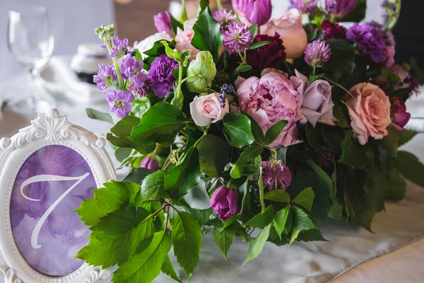 Table setting at wedding reception. Floral decoration and styliz