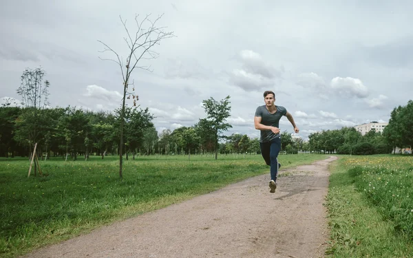 Jogging lifestyle - young attractive man running in park
