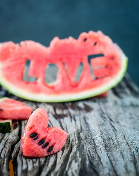 Fresh juicy watermelon slice  close-up with love letters word