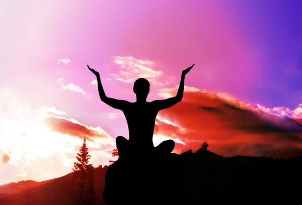 Yoga and meditation. Silhouette in mountains.