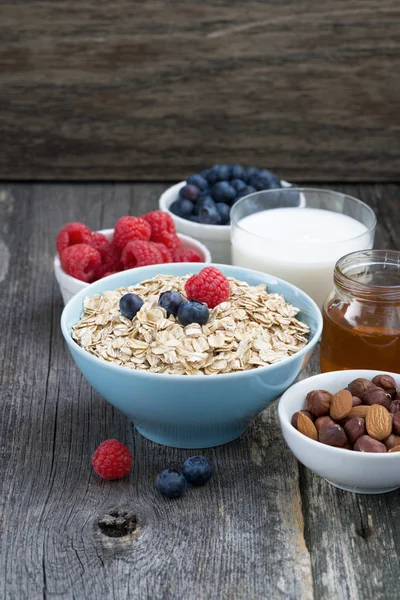 Fresh breakfast products on a wooden background, vertical
