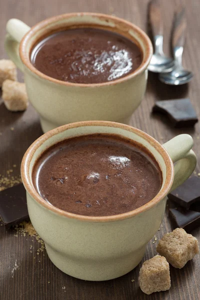 Two cups of hot chocolate and sugar cubes, close-up