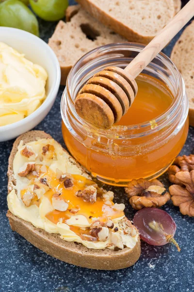 Honey, bread with butter and grape, vertical, top view