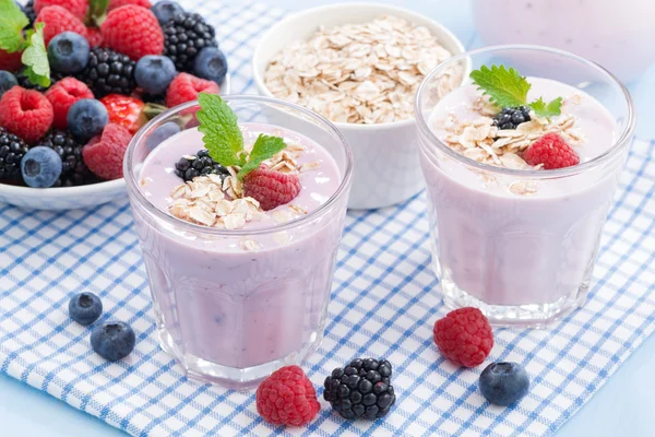 Healthy berry smoothies with oatmeal in a glass, top view