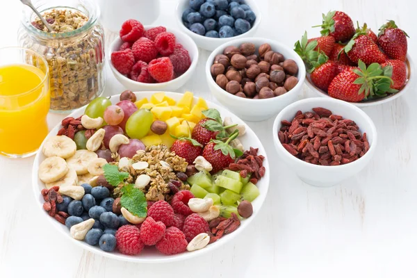 Products for a healthy breakfast - berries, fruit and cereal