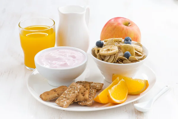 Healthy breakfast - cereal, fruit, yogurt and juice, close-up