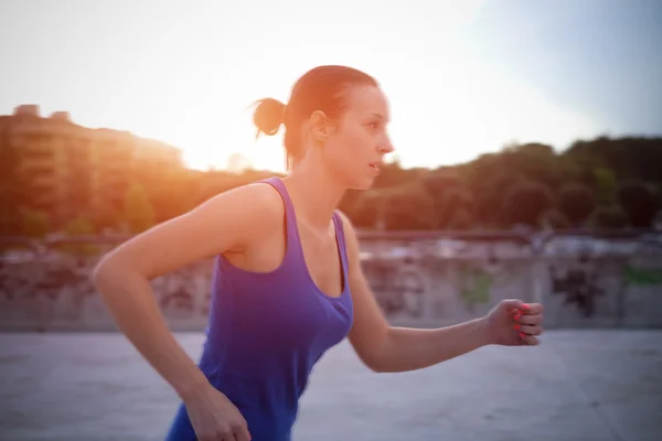 Sportive woman running outdoor in the city