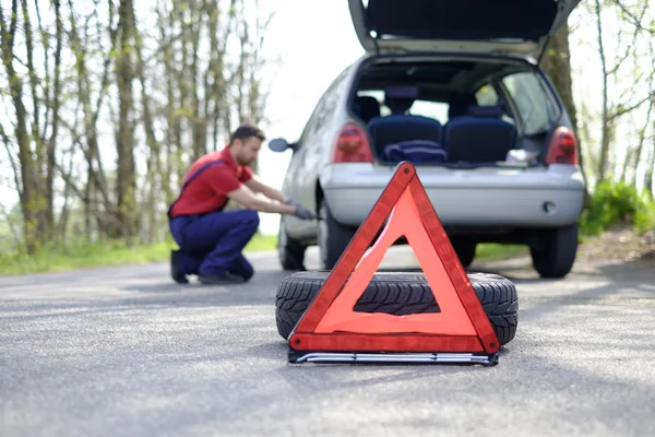 Man fixing a car problem after vehicle breakdown