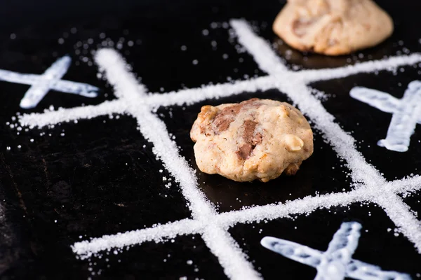 Chocolate chip cookies on noughts and crosses sugar grid