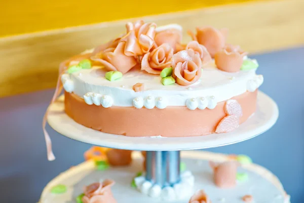 Delicious wedding cake with flowers, in white and orange
