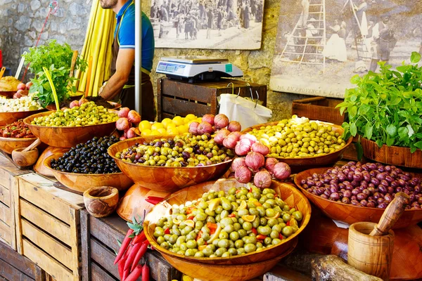 Marinated garlic and olives on provencal street market in Proven