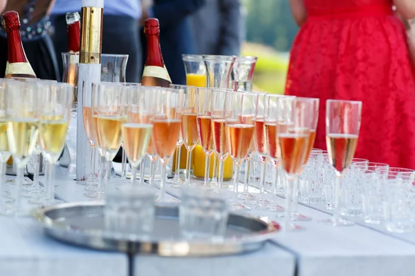 Glasses with champagne and wine on summer wedding