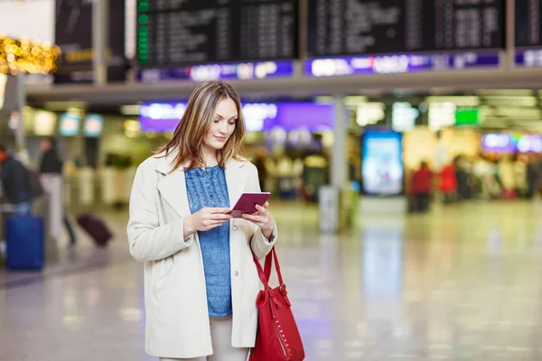 Woman at international airport waiting for flight at terminal