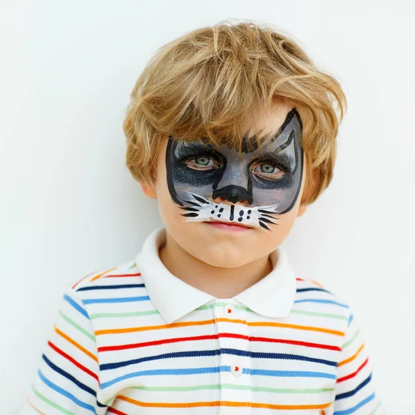 Little kid boy with face painted as animal