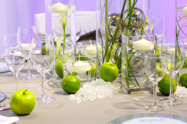 Elegant table set in green and white for wedding or event party.