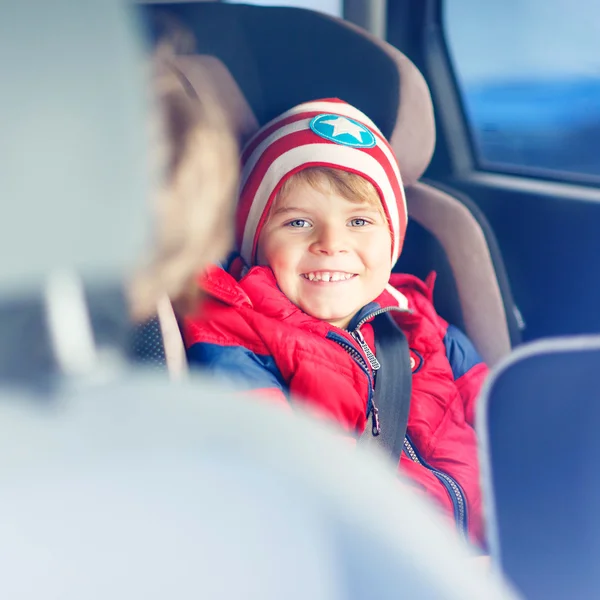 Portrait of preschool kid boy sitting in car