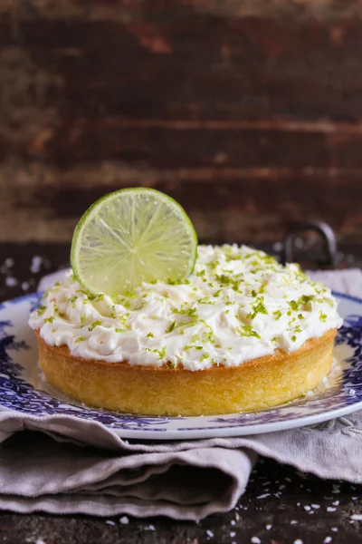 Pound cake with lemon, lime and freshly shredded coconut with cream cheese frosting