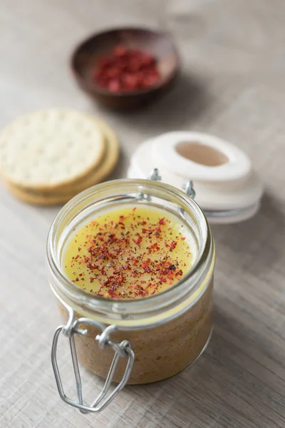 Chicken liver pate with butter and port wine in a jar with homemade crackers, selective focus