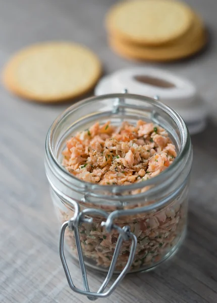 Roasted and smoked salmon fish, soft cheese and egg pate in glass jar, selective focus