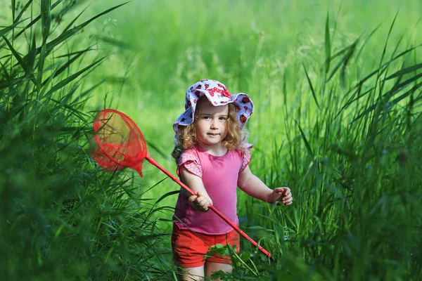 Girl with a net catching butterflies