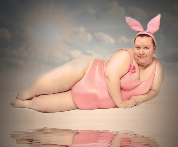 Woman Easter Bunny relaxing on the beach